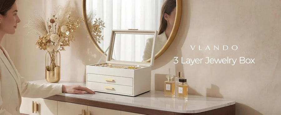 Woman standing beside a white three-layer jewelry storage case on a vanity.