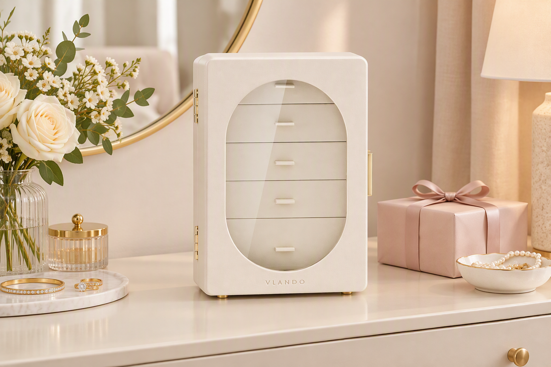 A jewelry box arranged on a dresser with neatly grouped jewelry nearby, presented as a polished gift option