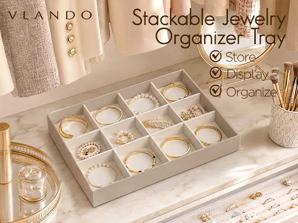 Beige Vlando Stackable Velvet Jewelry Organizer Tray with twelve bangle compartments on a marble vanity.