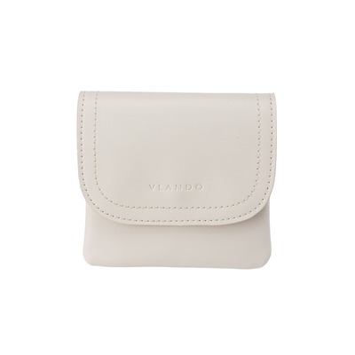 Beige VLANDO small travel jewelry case with stitched trim, flap closure and compact portable design